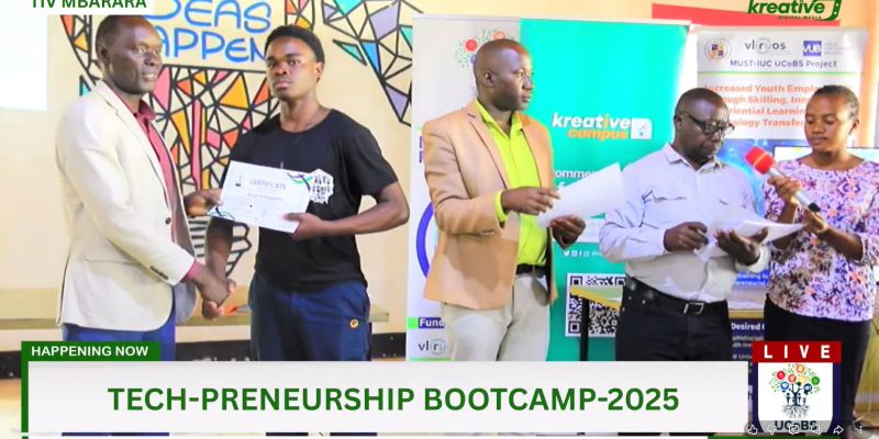 Receiving a certificate on stage at the Tech-Preneurship Bootcamp 2025, broadcast live from TIV Mbarara.