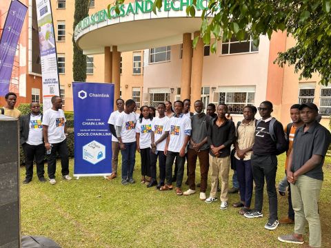 A crowd of students in matching event T-shirts gathered around a Chainlink banner outside the Faculty of Applied Sciences & Technology.
