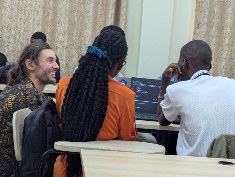 Participants working through exercises on their laptops during a Python training session.